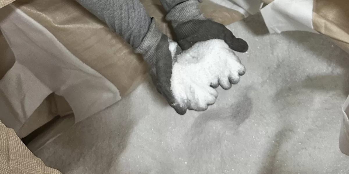Hands scooping glass cullet